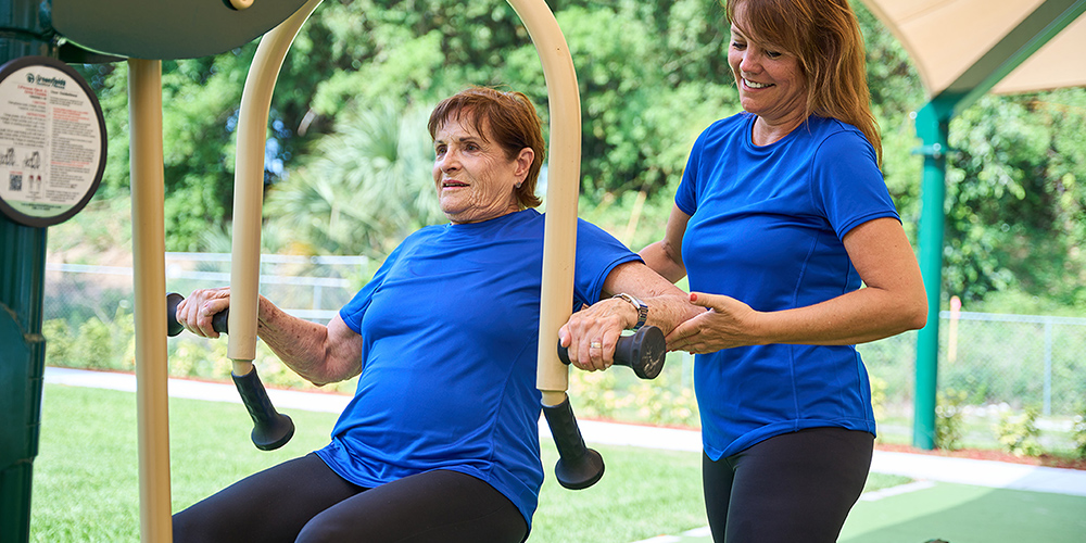 Seniors using outdoor fitness equipment